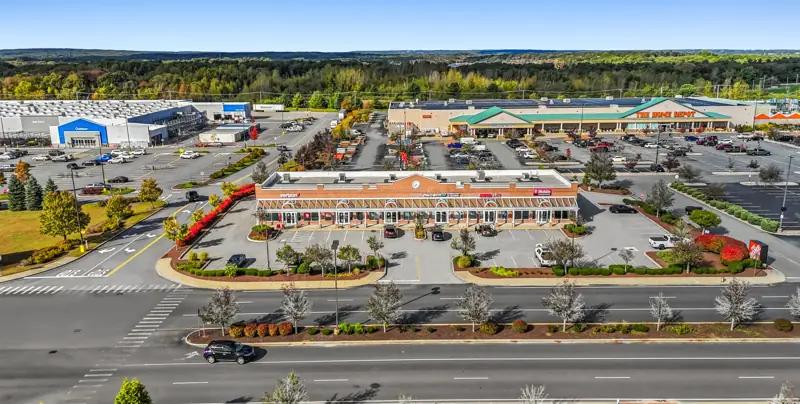 Aerial view of a large single-story retail property and parking lot, Coventry, Rhode Island.