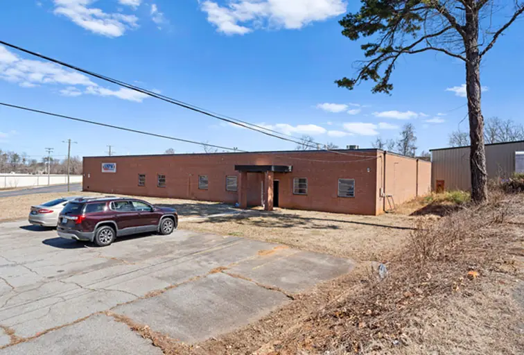 One-story brick industrial building with a paved lot, High Point, North Carolina.